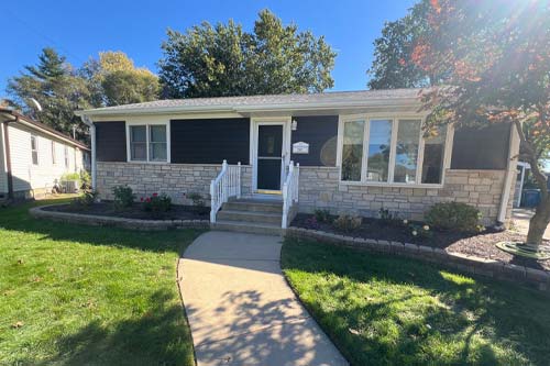 White frame door with front yard view.